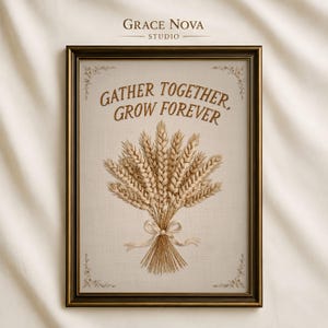 May include: A framed embroidery art piece featuring a wheat sheaf tied with a cream ribbon on a light fabric background. The text "GATHER TOGETHER, GROW FOREVER" is stitched in brown above the wheat. The frame is dark brown with a metallic finish.