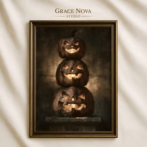 May include: A framed wall art print featuring a vertical stack of three carved jack-o'-lanterns with glowing interiors. The dark, textured pumpkins are set against a moody, shadowed background. The text Grace Nova Studio appears at the top.