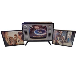 May include: A white ceramic mug with a black handle and the text "But First, Coffee" in a black, handwritten-style font. The mug is on a white surface.