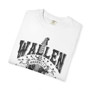 May include: White t-shirt with a black graphic design. The design features the name "WALLEN" in a distressed font, a guitar, and the word "NASHVILLE" on a banner. The shirt is folded.