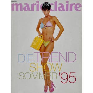 May include: A magazine cover with the title "marie claire" in pink. The model is wearing a colourful bikini, platform heels, and sunglasses. A yellow handbag is held in the model's hand. The text "DIE TREND SHOW SOMMER '95" is also visible on the cover.