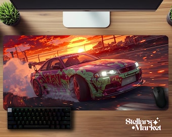 May include: A vibrant mousepad featuring a drifting sports car with a sunset backdrop. The car is painted in purple and green graffiti art. A black keyboard and mouse are visible.