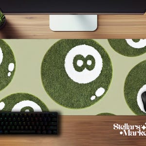 May include: A rectangular mouse pad featuring a repeating pattern of green and white 8-ball designs. The pad has a light green background and a black keyboard and mouse are visible on the pad. The Stellar's Market logo is in the bottom right corner.
