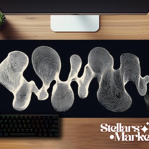 May include: Black rectangular mouse pad with a white, abstract, flowing design. A black keyboard and mouse are visible. The words "Stellars Market" are printed in white.