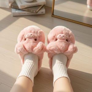 May include: A pair of pink plush pig slippers with detailed snouts, ears, and eyes. The slippers are worn with white ribbed socks. The image is taken from a low angle, showing the feet and part of the legs.