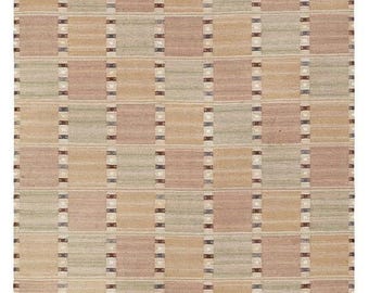 May include: A rectangular rug with a repeating pattern of squares and rectangles. The squares are in shades of beige, pink, and green. The rectangles are in shades of brown and blue. The rug has a neutral color palette.