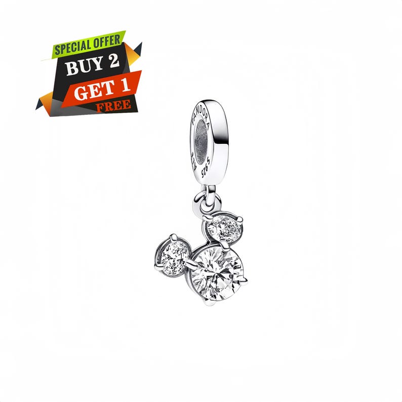 May include: A silver charm with a Mickey Mouse design, featuring three clear, sparkling cubic zirconia stones. The charm has a loop at the top for attachment. The image also includes a promotional banner that says "SPECIAL OFFER BUY 2 GET 1 FREE".
