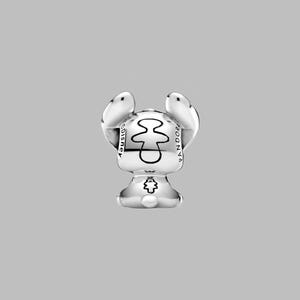 May include: A silver charm featuring a stylized character with large ears and a small body. The charm has the word "Disney" on one side and "Pandora" on the other. The character's design includes a central shape and a small emblem on the bottom.