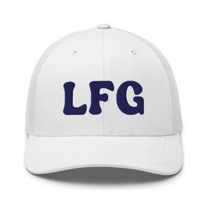 May include: White trucker cap featuring the navy blue letters "LFG" embroidered on the front. The cap has a mesh back and a curved peak. A casual accessory for everyday wear.