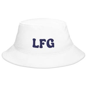 May include: White bucket hat with the navy blue letters "LFG" embroidered on the front. The hat has a rounded crown and a downward-sloping brim. The hat is made of a soft, durable material.