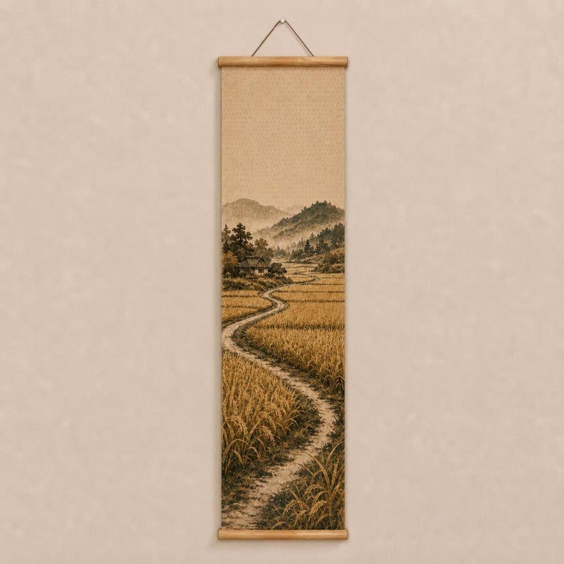 May include: A vertical wall hanging scroll featuring a sepia-toned landscape illustration of a winding dirt path through golden fields of grain, leading toward a small house nestled at the base of rolling mountains under a soft, hazy sky.
