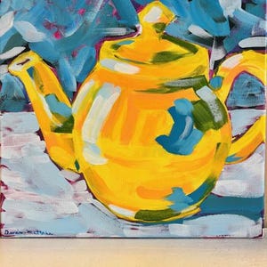 May include: A vibrant painting of a yellow teapot with a lid, handle, and spout. The teapot is set against a background of blue, white, and pink brushstrokes. The artwork is signed in the lower left corner.
