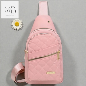 May include: A pink quilted sling bag with a gold zip and adjustable strap. The bag features a diamond pattern and a small gold label. Designed to be worn across the body.