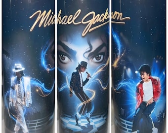 May include: A cylindrical tumbler featuring a dark blue background with starry accents and the name Michael Jackson in gold script. The design displays three distinct images of Michael Jackson in various iconic outfits and poses, surrounded by blue light.
