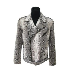 May include: A snakeskin-effect jacket in grey and white. The jacket has an asymmetrical zip, a notched collar, and a belt at the waist. It is displayed on a black turtleneck.