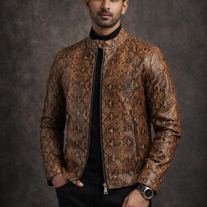 May include: A brown snakeskin-patterned leather jacket with a black turtleneck and black pants. The jacket has a zipper closure and a stand-up collar. A watch is visible on the wrist. The overall style is fashionable and modern.