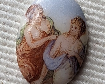 May include: Oval shaped cameo with a painted scene of two women in a light blue, brown, and white colour scheme.