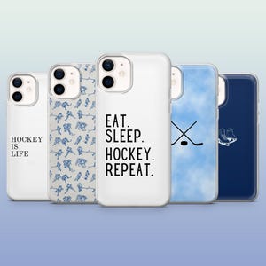May include: A collection of five phone cases with hockey-themed designs. One case reads "HOCKEY IS LIFE," another features a pattern of hockey players, and a third says "EAT. SLEEP. HOCKEY. REPEAT." The remaining cases display a hockey stick and a pair of ice skates.
