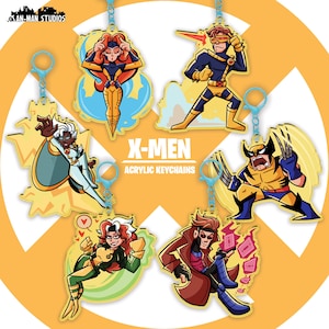 May include: Six acrylic keychains featuring cartoon illustrations of X-Men characters including Jean Grey, Cyclops, Storm, Wolverine, Rogue, and Gambit. Each keychain has a light blue clasp. The text X-MEN ACRYLIC KEYCHAINS is centered.