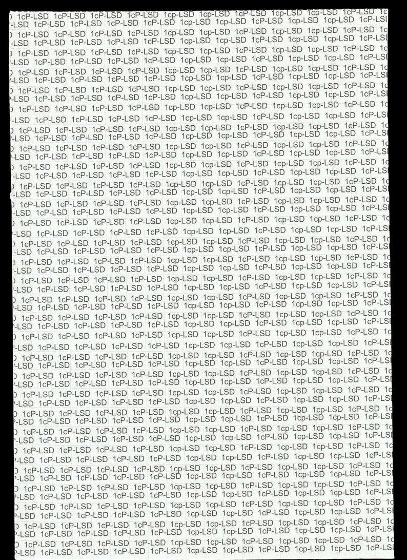 "1cP-LSD" on a blank white Blotter paper with black background. The text is in a sans-serif font and is repeated in rows and columns, creating a dense, all-over design.