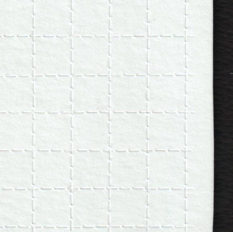 May include: Close-up of a white, textured paper with a grid pattern. The grid is formed by embossed, dashed lines creating a series of squares. The paper has a slightly rough, fibrous texture.