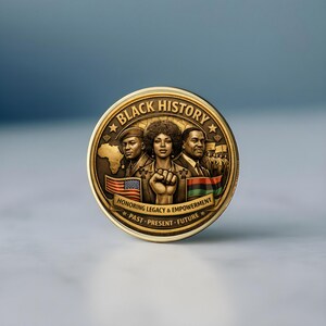 Close-up of Black History coin showing detailed relief design and antique gold finish
