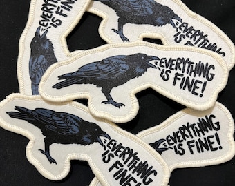 May include: A collection of embroidered patches featuring a black raven with the text "EVERYTHING IS FINE!" in white. The raven is depicted with its beak open, and the patches have a white border.