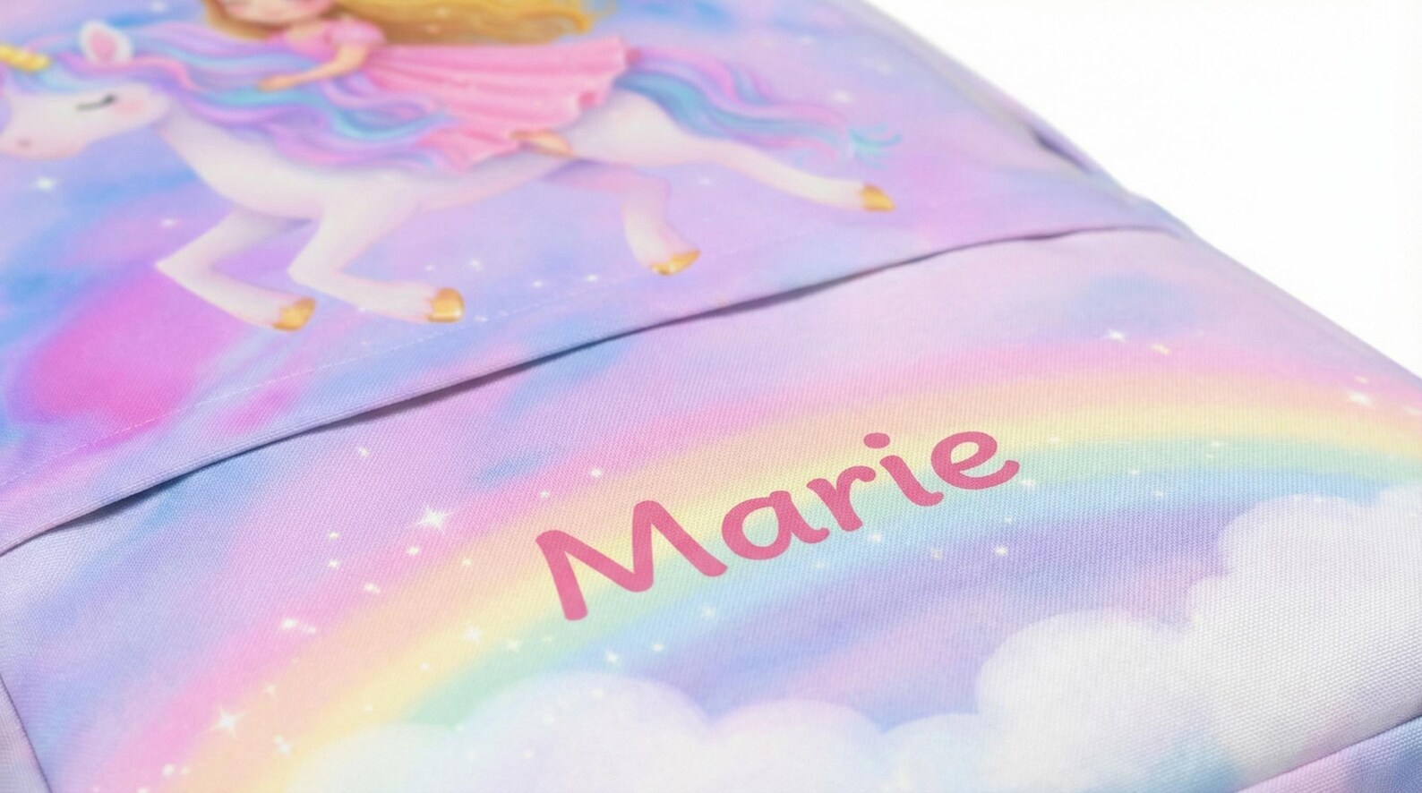 Side view of the unicorn backpack showing the mesh back panel and adjustable straps
