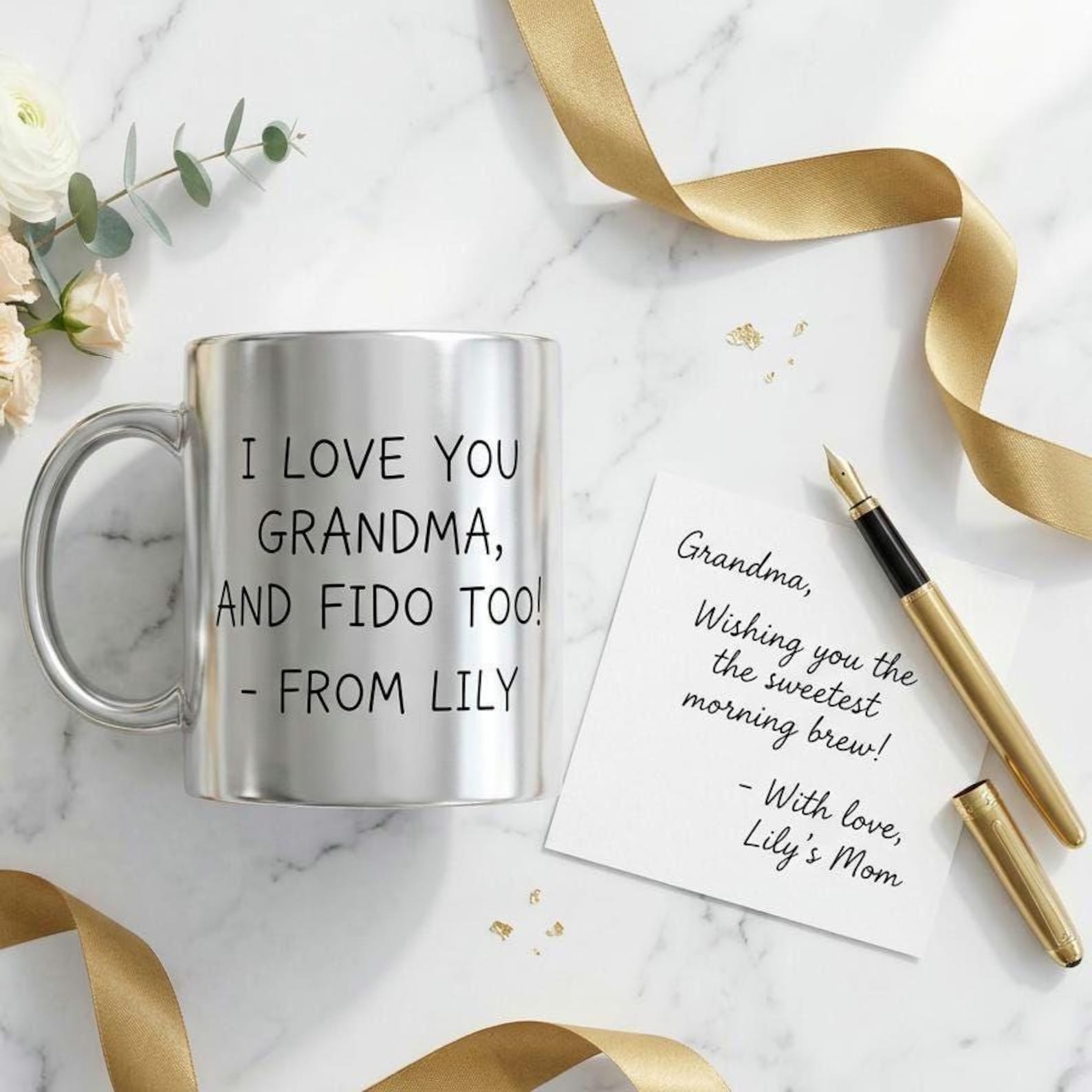 Silver metallic mug printed with the handwritten message "I love you Grandma, and Fido too! - From Lily", beside a matching handwritten note and a gold fountain pen