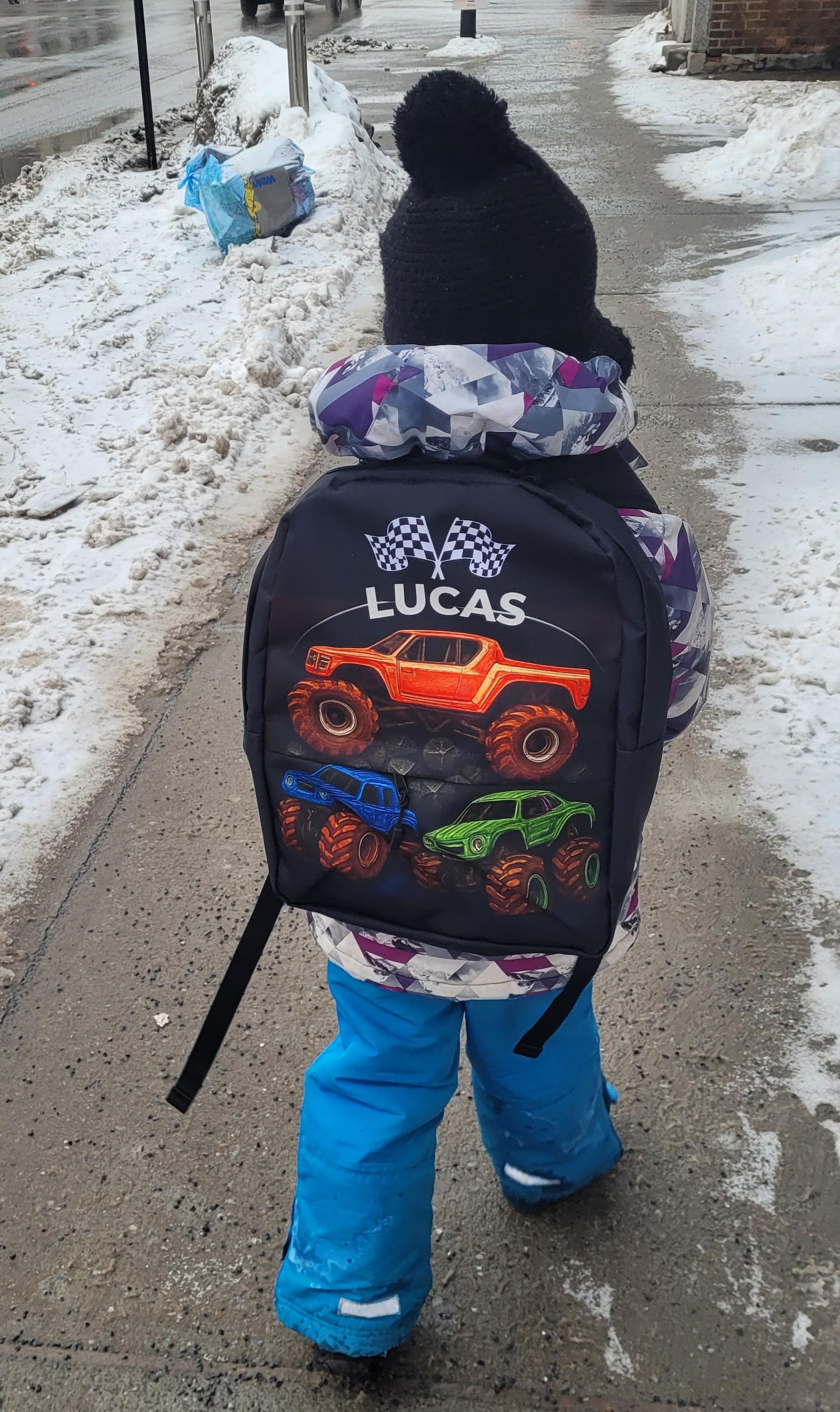 The monster truck backpack shown from the front, displaying the full truck illustration