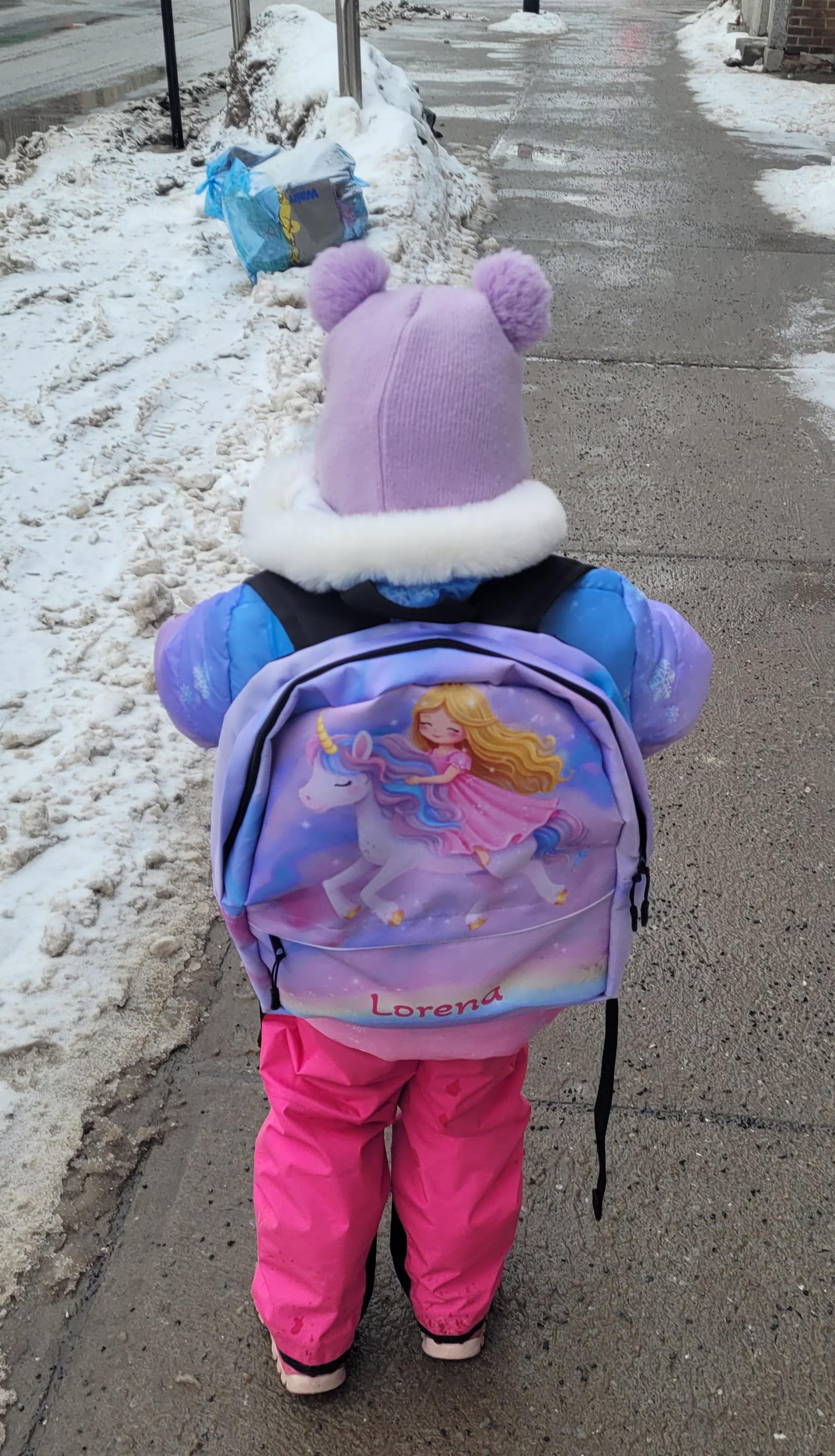 The unicorn backpack's front zipper pocket and side pocket