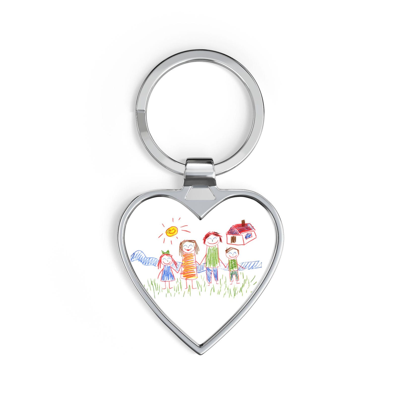 Studio shot of the heart-shaped silver keychain printed with a child's drawing of a family, sun, and house