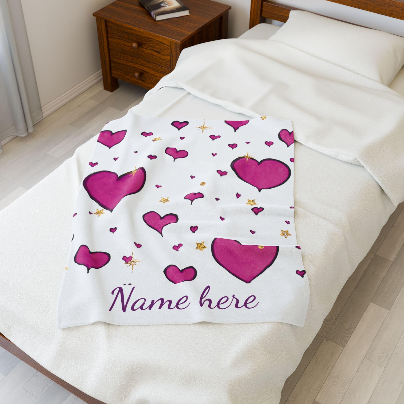 The pink heart blanket spread out on a bed, showing the full pattern