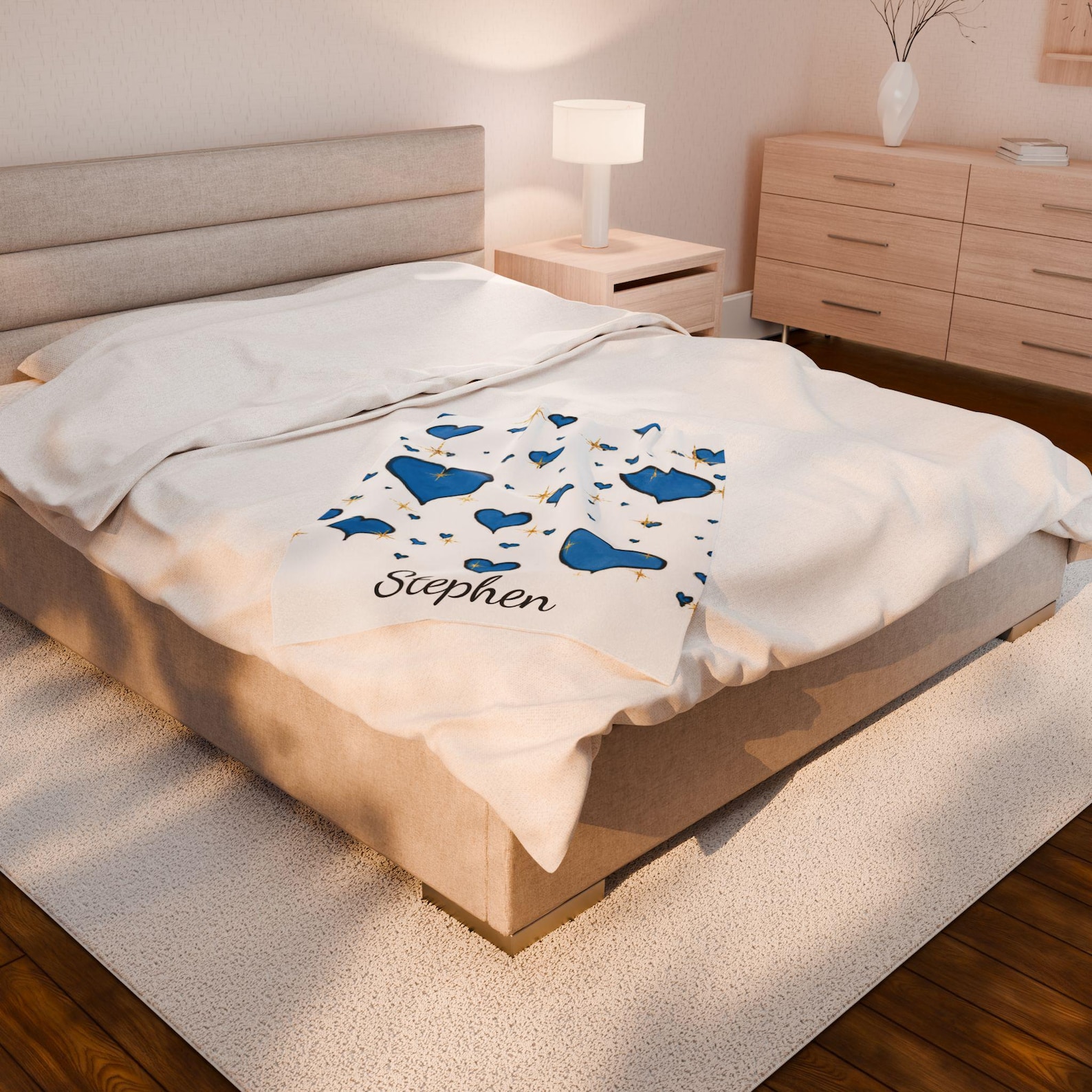 The folded plush blanket personalized with the name "Stephen", showing the blue heart pattern