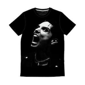 May include: Black t-shirt featuring a black and white image of a person with their mouth wide open, screaming. The person is wearing a necklace and a jacket. The image is centered on the front of the shirt.