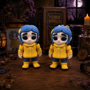 May include: Two figurines of a character with blue hair, yellow coat, and blue pants. The figurines are standing on a wooden surface. The background includes a framed picture, a book, and a candle.