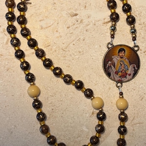 May include: A set of three ceramic mugs with a speckled, matte finish. The mugs are in shades of cream, light gray, and dark gray. Each mug has a simple, minimalist design, perfect for coffee or tea.