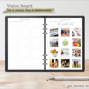May include: A black vision board notebook with the text "Vision Board" and "See it clearly. Plan it intentionally." The notebook is open, displaying blank squares and images related to health and wellness. A pen rests on the wooden surface.