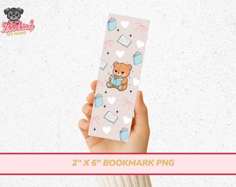 May include: A bookmark featuring a cute cartoon bear reading a book, surrounded by hearts, books, and bows on a light pink background. The bookmark is 2 inches wide and 6 inches long.