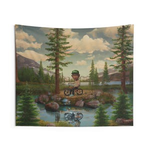 May include: A tapestry featuring a whimsical illustration of a person riding a bicycle in a serene outdoor setting. The artwork depicts a person wearing a striped shirt and a green cap, riding a bicycle near a body of water, surrounded by trees and mountains.