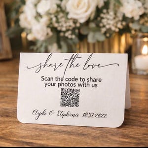 May include: A white ceramic mug with a black handle and the text "But First, Coffee" in a black, handwritten-style font. The mug is on a white surface.