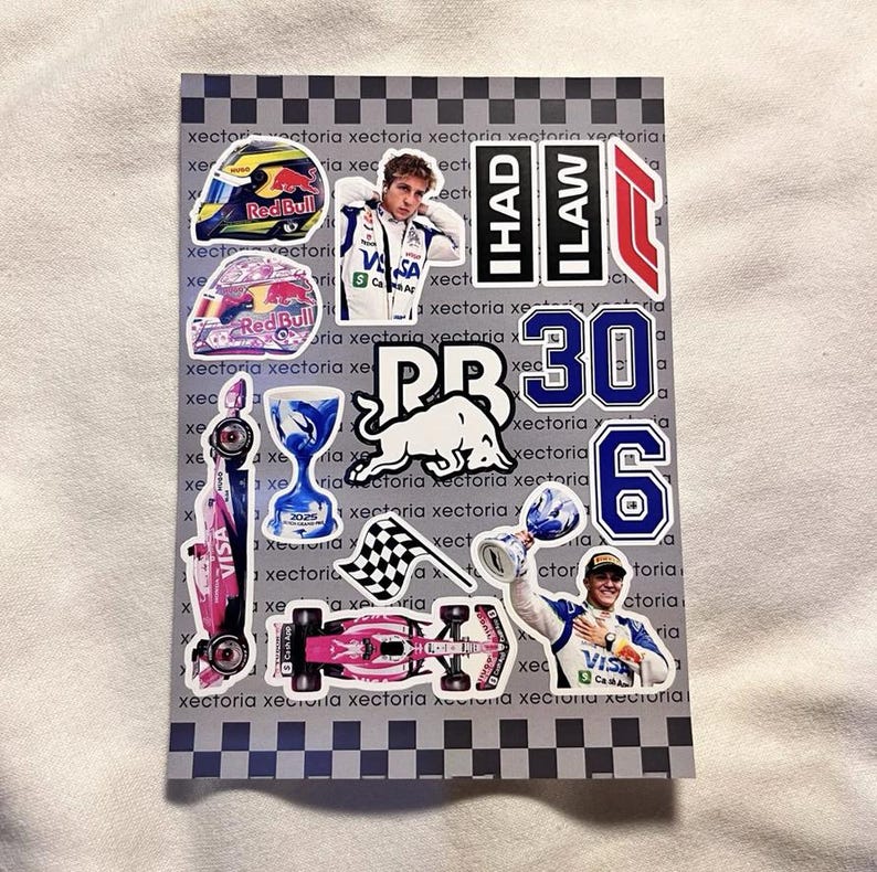May include: A sheet of stickers featuring Formula 1 racing themes. Includes stickers of helmets, race cars, trophies, and drivers. The stickers have the Red Bull logo, the numbers 30 and 6, and the text "IHAD ILAW".