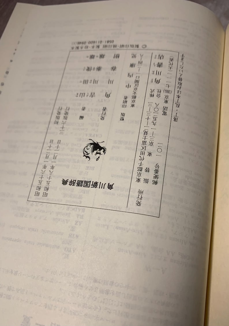 May include: A white ceramic mug with a black handle and the text "But First, Coffee" in a bold, black font. The mug is set against a blurred background, suggesting a cozy setting. The mug appears to be approximately 4 inches tall.