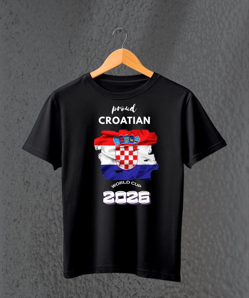 May include: Black t-shirt with the text "proud CROATIAN" above a Croatian flag design. The flag is red, white, and blue with a checkered emblem. Below the flag is "WORLD CUP 2026" in white.
