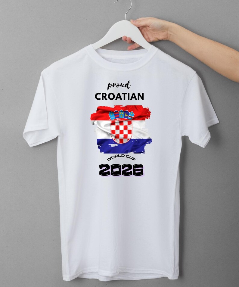 May include: White t-shirt with the text "proud CROATIAN" above a Croatian flag design. The flag is red, white, and blue with the Croatian coat of arms. Below the flag is "WORLD CUP 2026" in black.