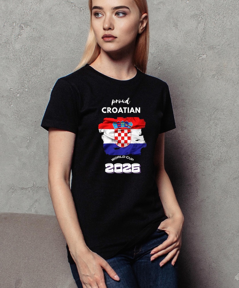 May include: Black t-shirt featuring the Croatian flag design with the words "proud Croatian" and "World Cup 2026" in white. The flag design includes red, white, and blue colors. The shirt is a crew neck style.