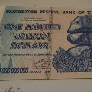 May include: A trio of cream-glazed ceramic mugs, each adorned with a hand-painted floral pattern in blue, green, and yellow hues. The mugs have a rounded form and a practical handle. The speckled glaze adds a rustic charm.