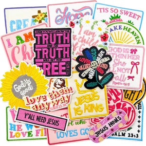 May include: A collection of embroidered patches with various designs and text. The patches feature phrases like "Jesus is King," "Y'all Need Jesus," and "Jesus Heals." Colors include pink, yellow, white, and blue. Some patches have floral and sunflower motifs.