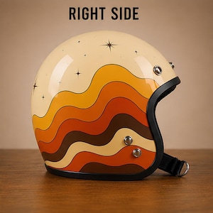 May include: A cream-coloured open-face motorcycle helmet featuring a graphic of wavy, layered bands in shades of yellow, orange, and brown. The upper section displays black star icons. The text RIGHT SIDE is printed above the helmet.
