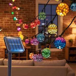 May include: A decorative string of multi-coloured globe lights, powered by solar energy. The lights are in various colours, including red, green, blue, and purple. The lights are strung on a black wire. A solar panel is visible.
